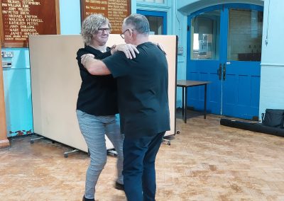 Mervyn showing participant a new dance.