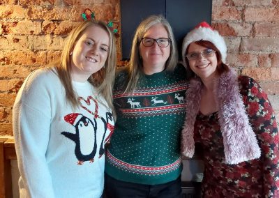 Staff Christmas meal 2022 - Three women in Xmas jumper3