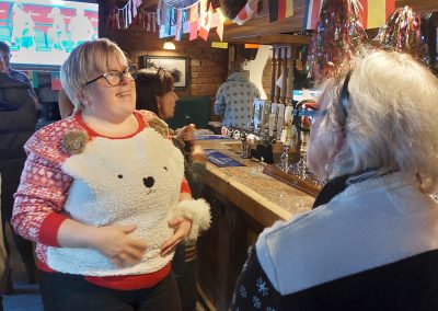 Staff Christmas meal 2022 - Two women chatting in Xmas jumper
