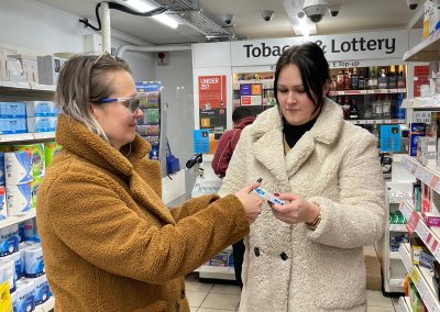 Deafblind workshop - guiding in the shop by the medical aisle.
