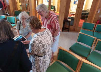 Group looking at the tablet shown by the trainer.